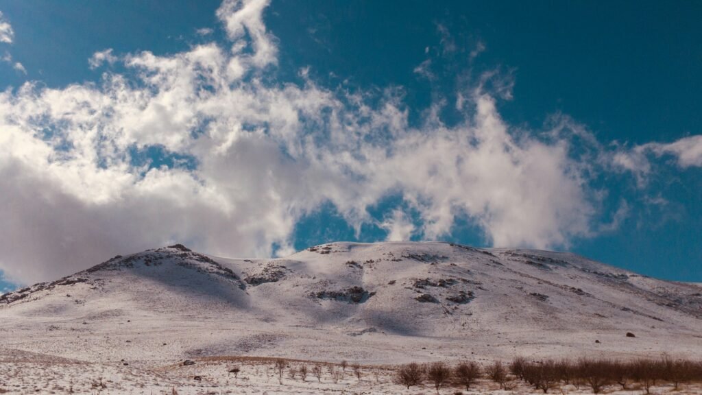 mountain under white cloudy skies